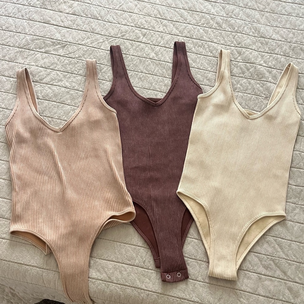 Three tank top bodysuits